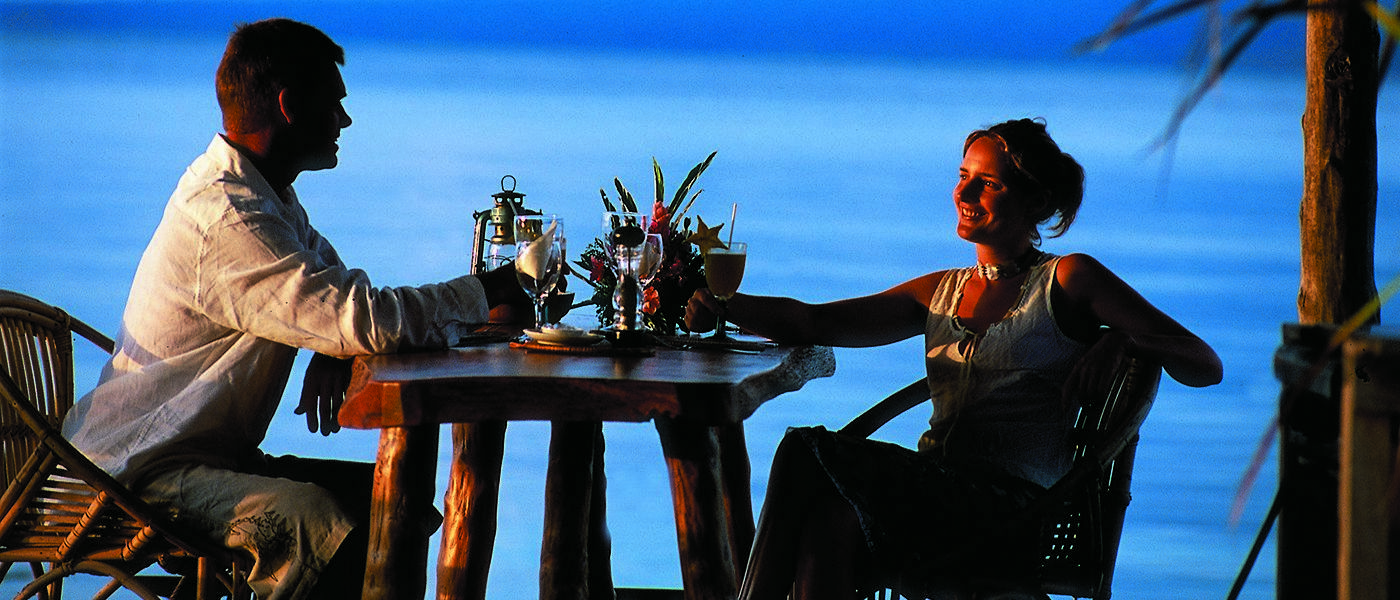 A couple enjoying cocktails at sunset